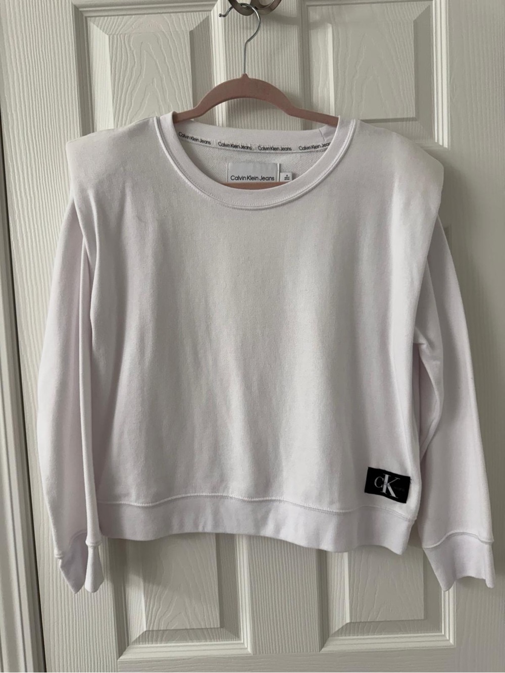 Calvin Klein White Pullover Sweatshirt with Black Logo Patch Shoulder pads